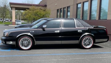 Vogue 235/55R17 White/Red tires on a 2000 CADILLAC DE VILLE