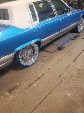 Vogue 245/40R20 White/Blue tires on a 1990 Cadillac Brougham